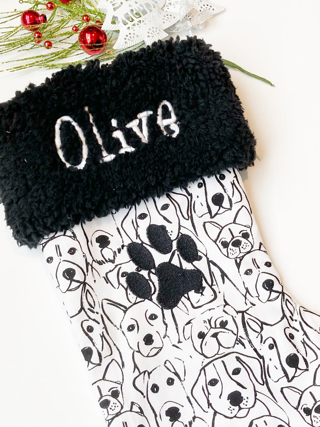Personalized Pet Christmas stocking in dog faces outlines, classic black and white print with black cuff and fully lined, embroidered paw