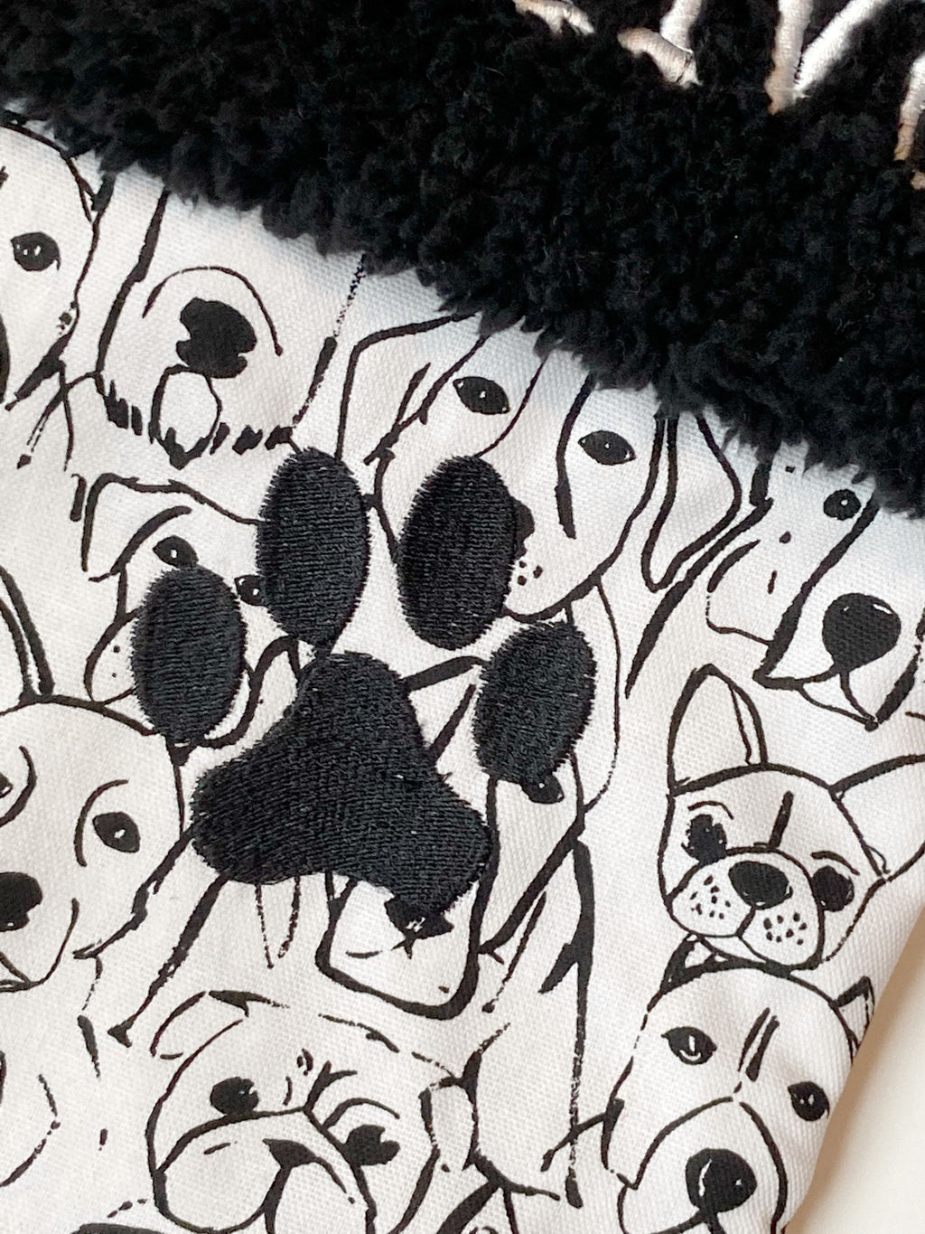 Personalized Pet Christmas stocking in dog faces outlines, classic black and white print with black cuff and fully lined, embroidered paw