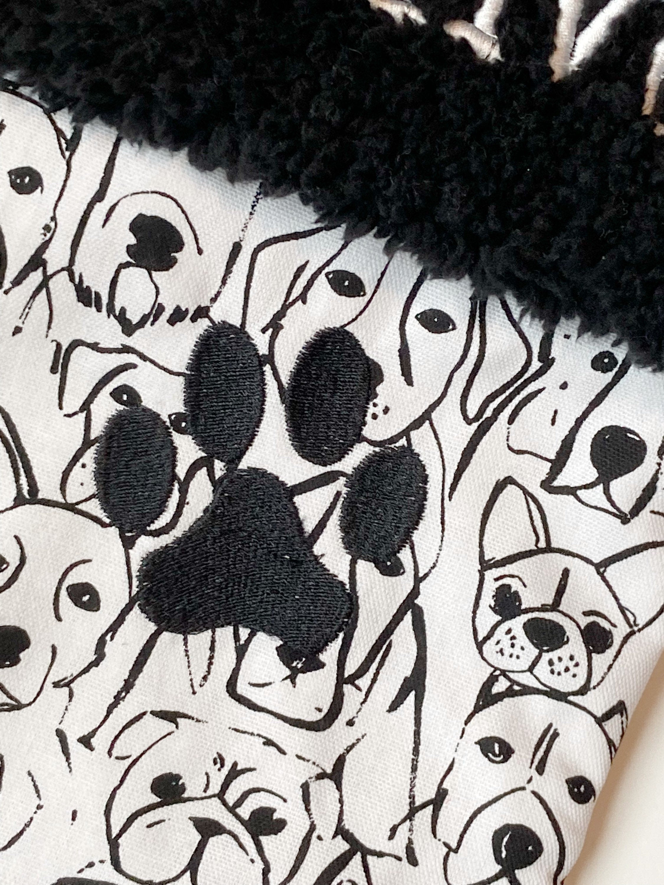 Personalized Pet Christmas stocking in dog faces outlines, classic black and white print with black cuff and fully lined, embroidered paw