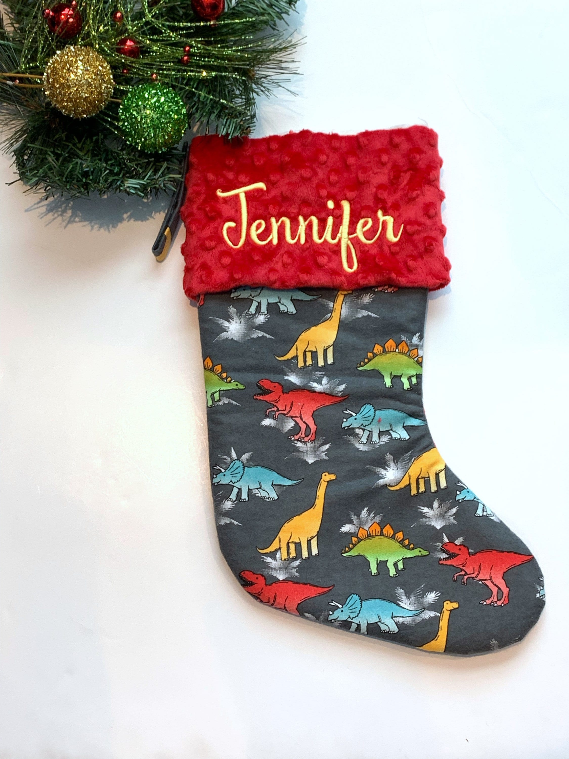Personalized Christmas stocking in flannel dinosaur  fabric, fully lined with minky dot cuff, 18” length, unique child stocking