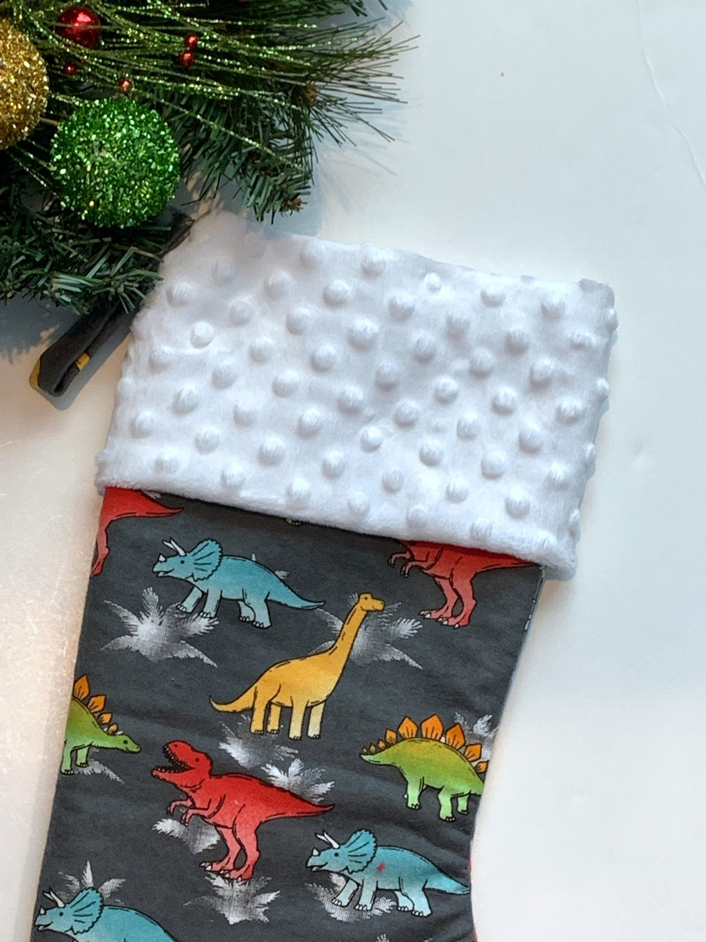 Personalized Christmas stocking in flannel dinosaur  fabric, fully lined with minky dot cuff, 18” length, unique child stocking
