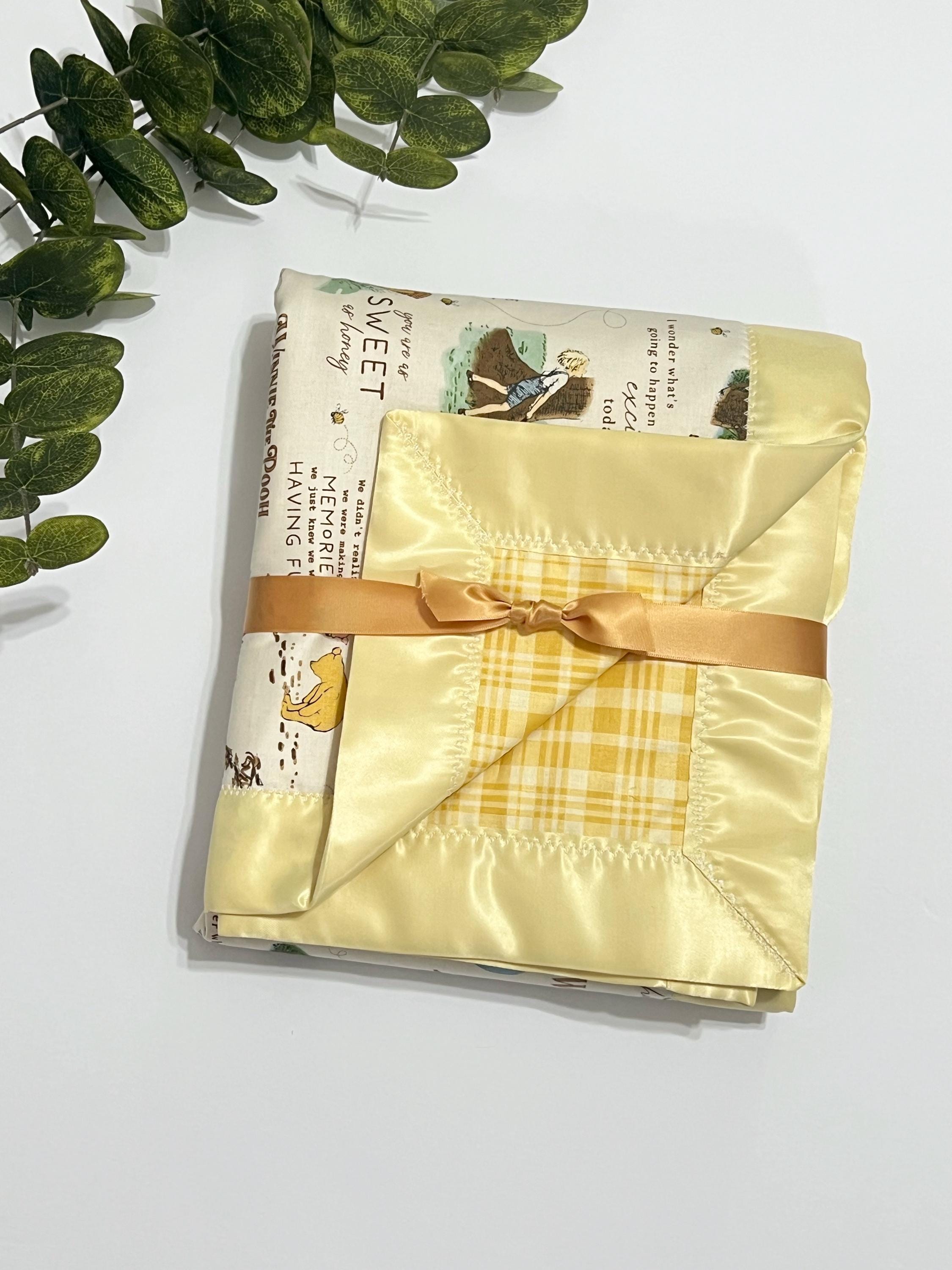 Baby crib blanket in classic Winnie the Pooh cotton with coordinating cotton on the back trimmed in satin binding, personalize option