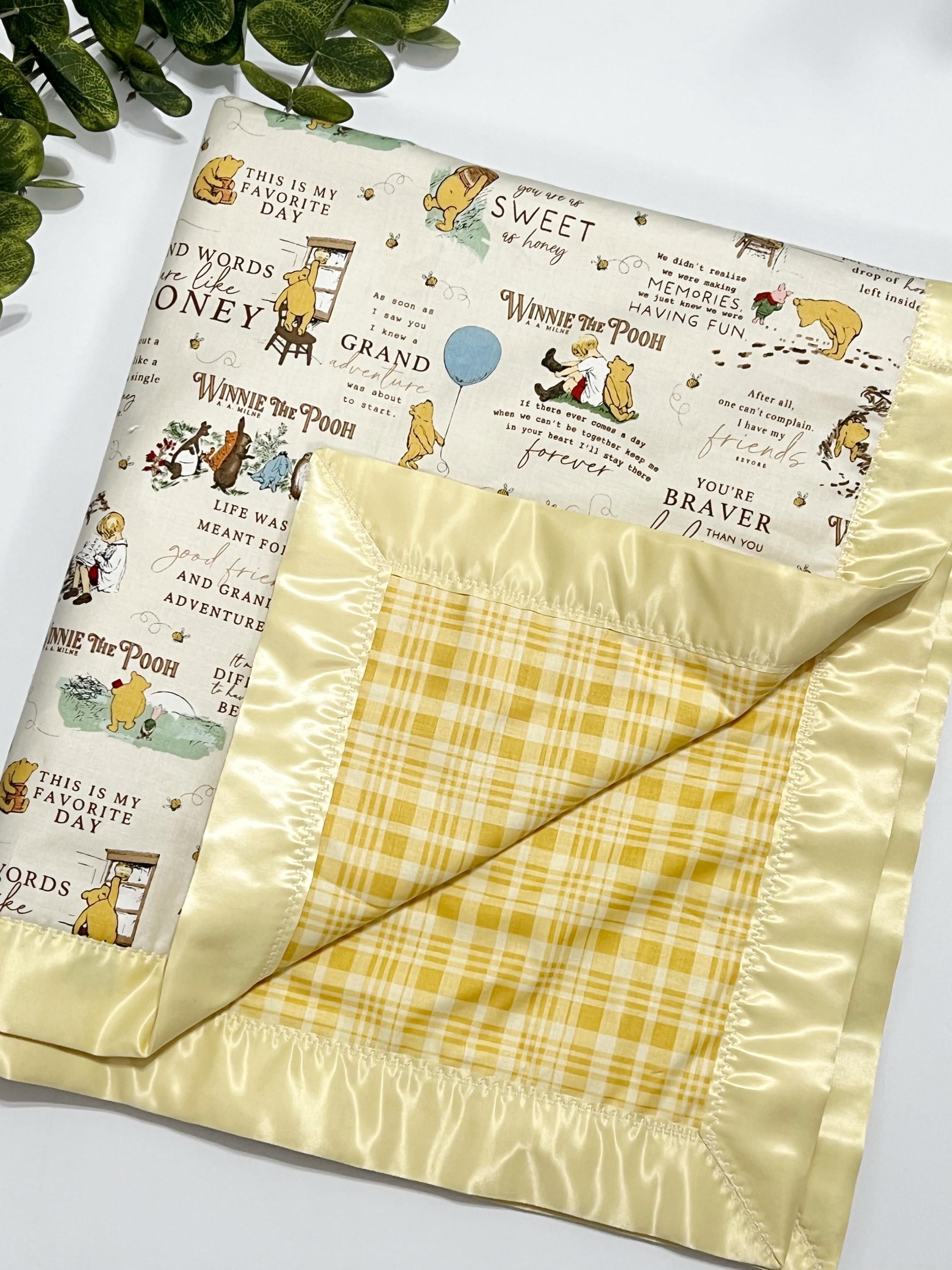 Baby crib blanket in classic Winnie the Pooh cotton with coordinating cotton on the back trimmed in satin binding, personalize option