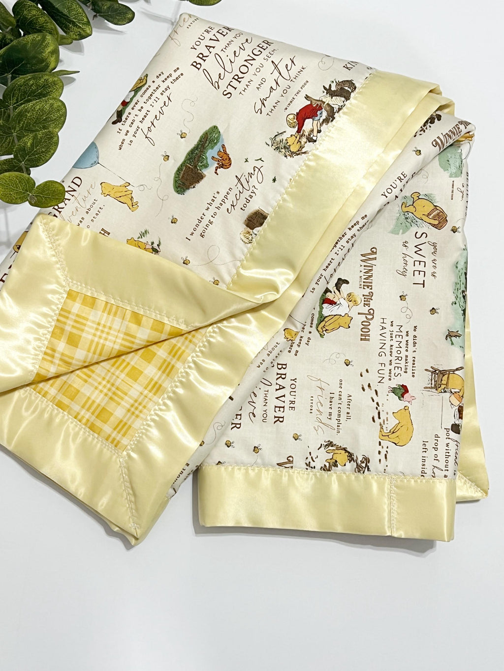 Baby crib blanket in classic Winnie the Pooh cotton with coordinating cotton on the back trimmed in satin binding, personalize option