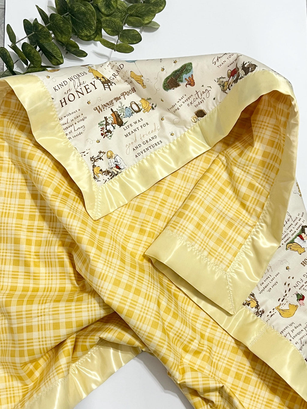Baby crib blanket in classic Winnie the Pooh cotton with coordinating cotton on the back trimmed in satin binding, personalize option