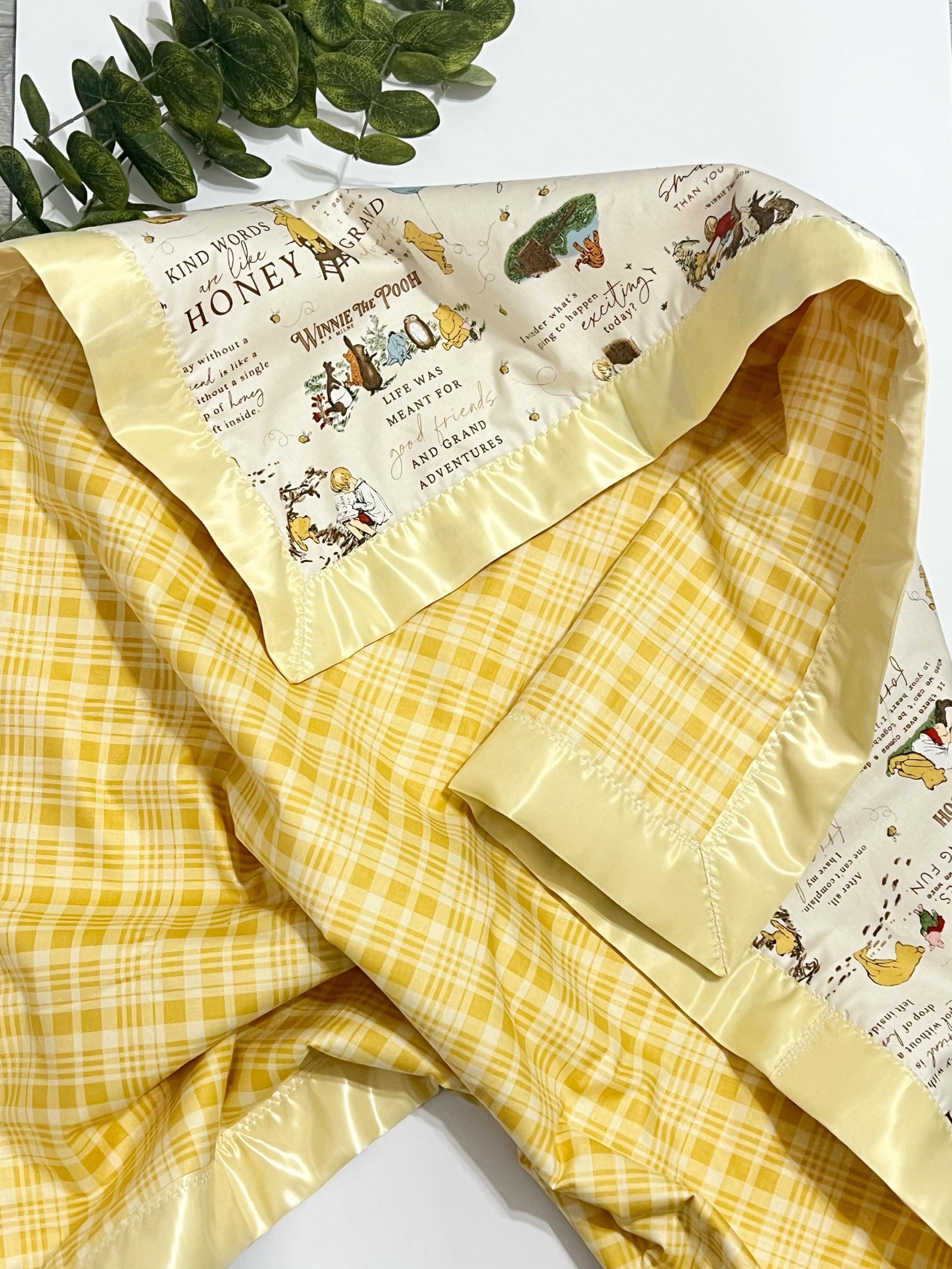 Baby crib blanket in classic Winnie the Pooh cotton with coordinating cotton on the back trimmed in satin binding, personalize option