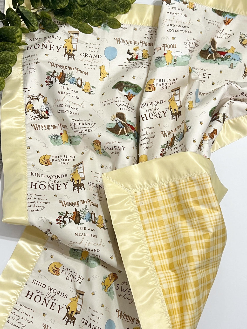 Baby crib blanket in classic Winnie the Pooh cotton with coordinating cotton on the back trimmed in satin binding, personalize option