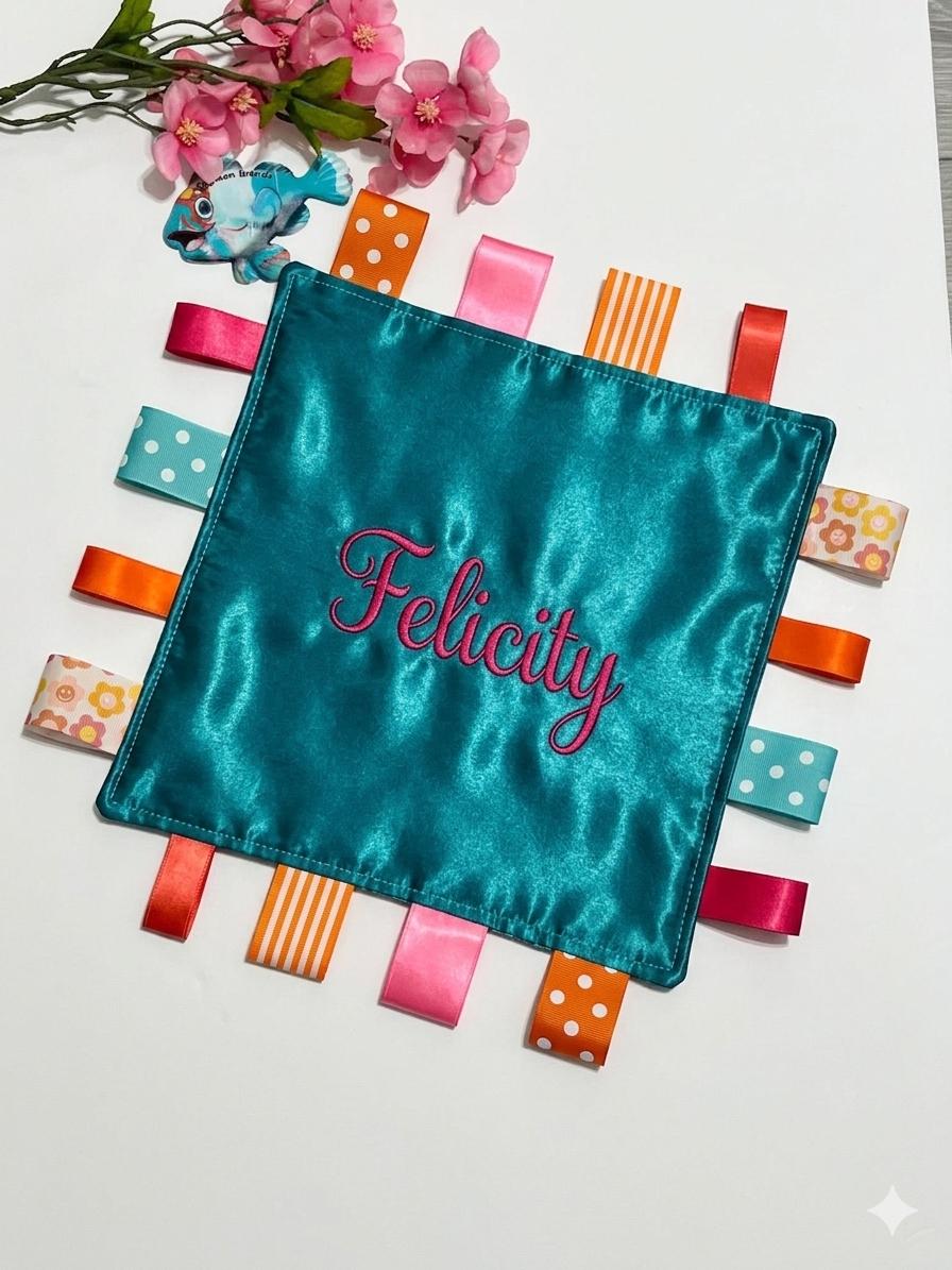 Double sided satin sensory lovey in ocean coral, hot pink, turquoise and orange with ribbon tags, and batting layer, comfort for baby, adult