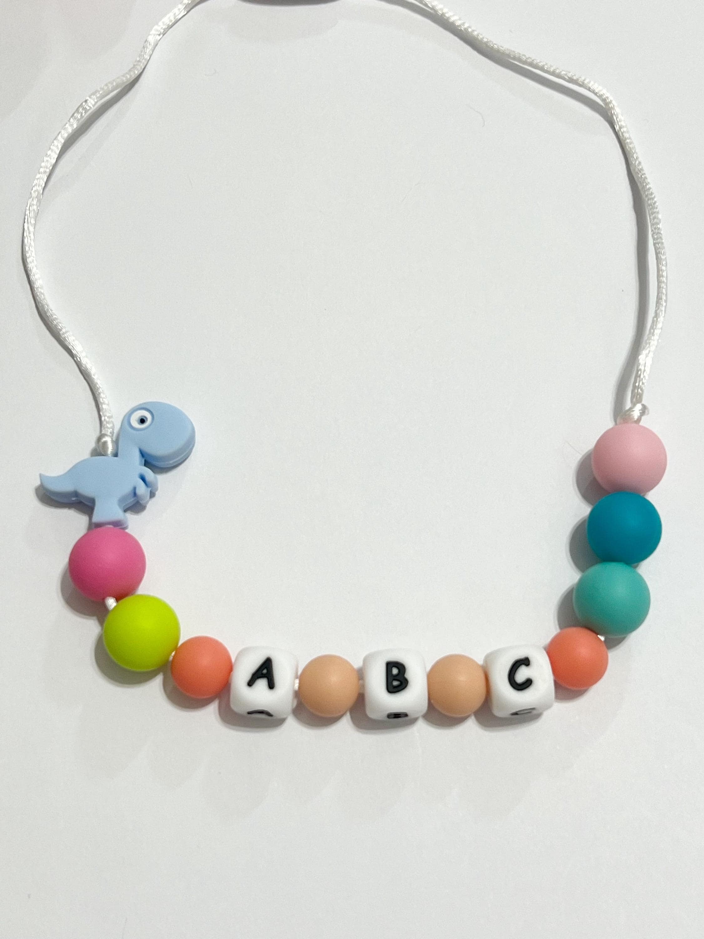 Toddler or child personalized necklace made from baby safe silicone beads, safe release clasp, colorful, plus a character or unique bead