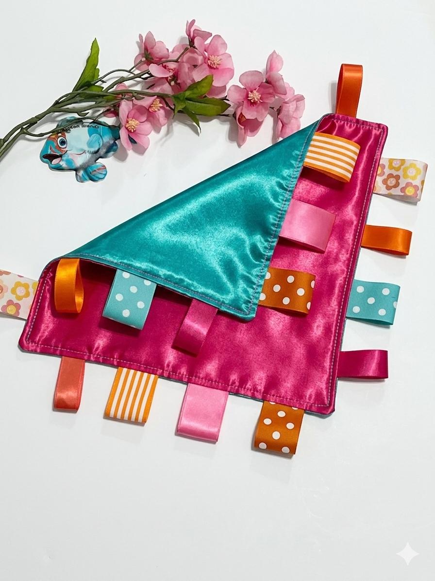 Double sided satin sensory lovey in ocean coral, hot pink, turquoise and orange with ribbon tags, and batting layer, comfort for baby, adult