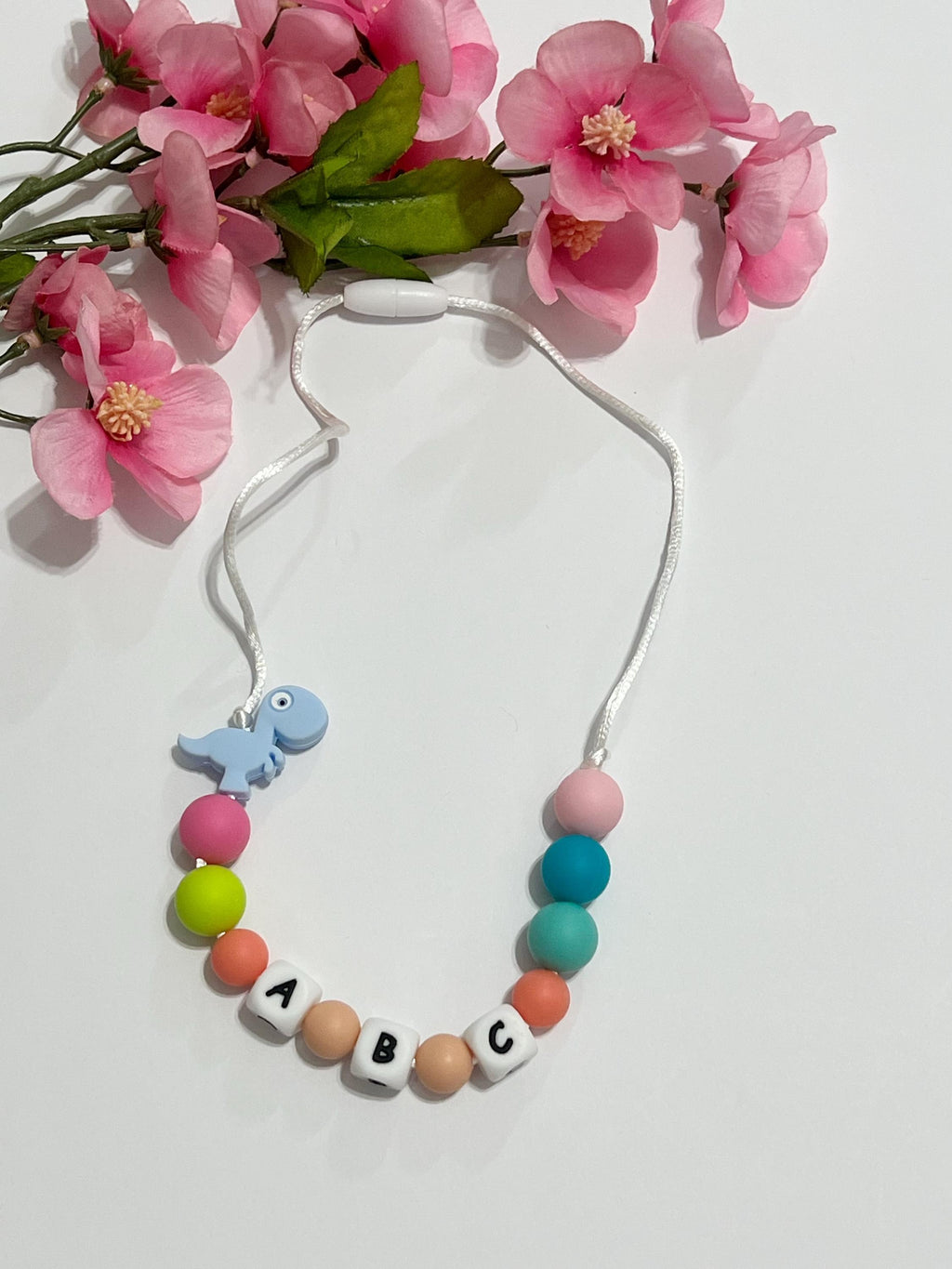 Toddler or child personalized necklace made from baby safe silicone beads, safe release clasp, colorful, plus a character or unique bead