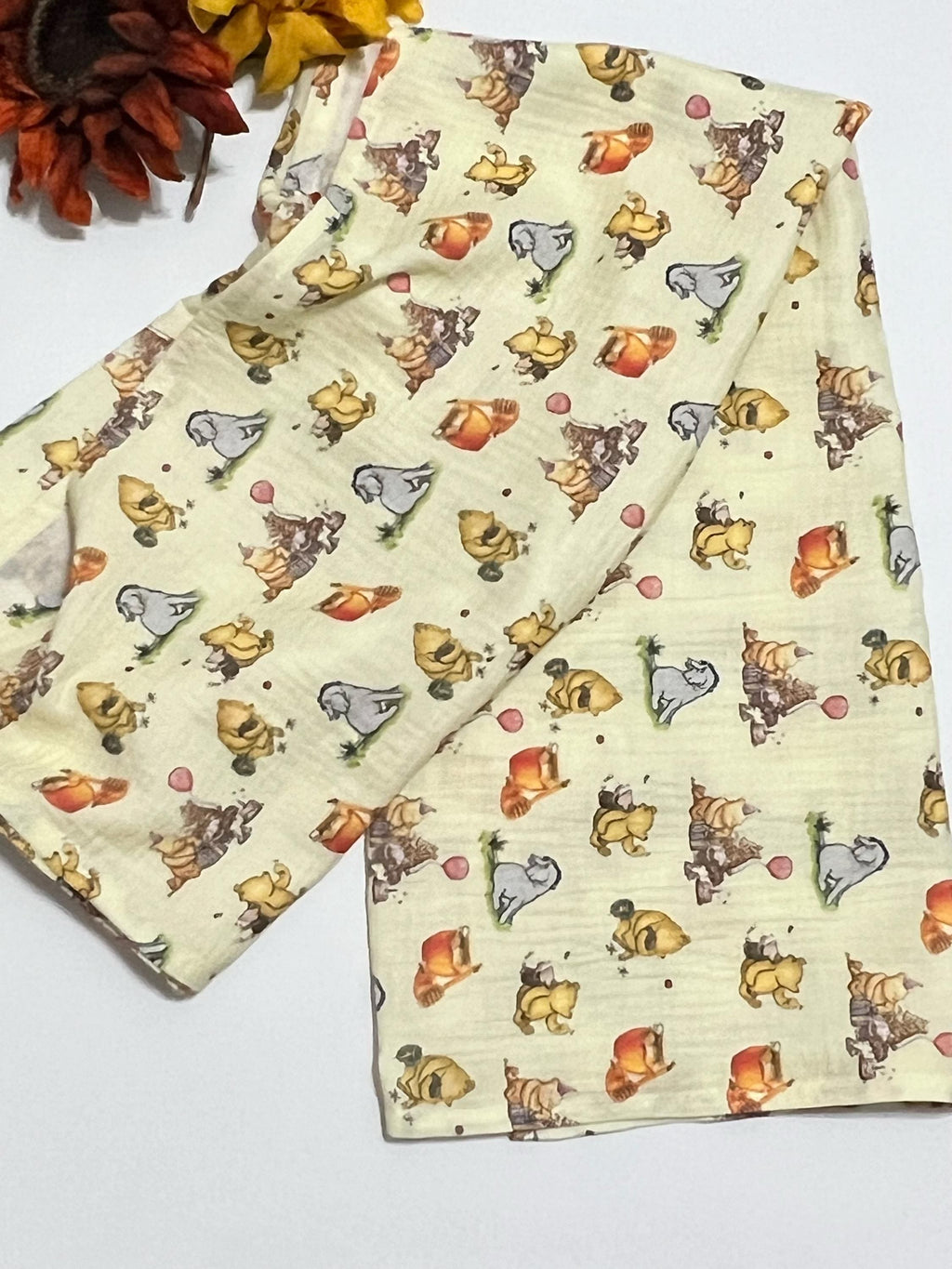 Baby swaddle blanket in classic Winnie the Pooh and Eeyore print yellow muslin gauze extra large 41”, soft and lightweight fabric, baby gift