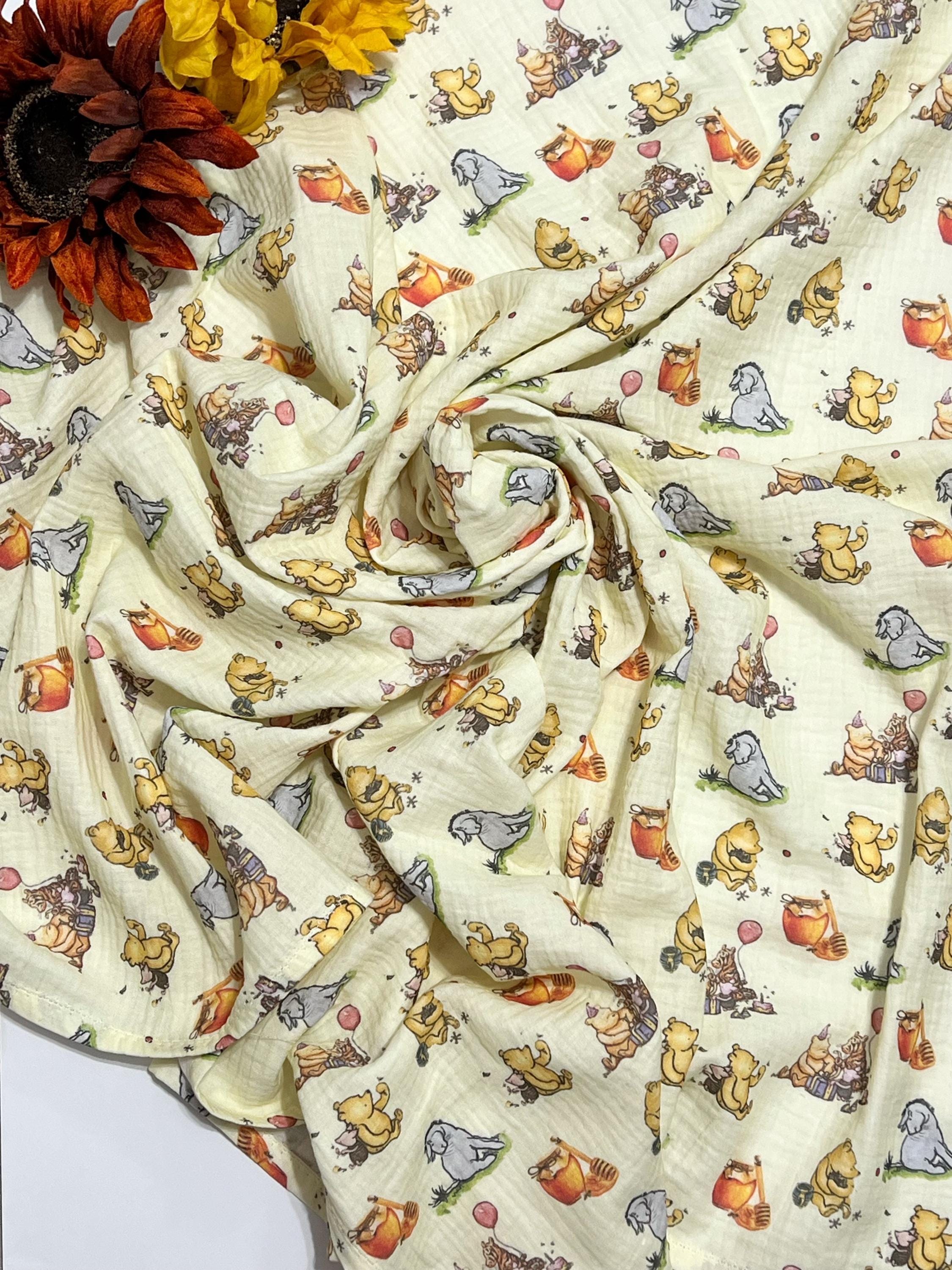 Baby swaddle blanket in classic Winnie the Pooh and Eeyore print yellow muslin gauze extra large 41”, soft and lightweight fabric, baby gift
