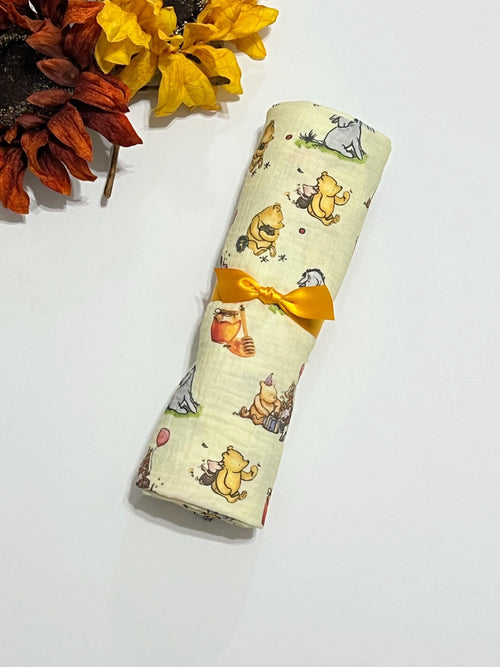 Baby swaddle blanket in classic Winnie the Pooh and Eeyore print yellow muslin gauze extra large 41”, soft and lightweight fabric, baby gift
